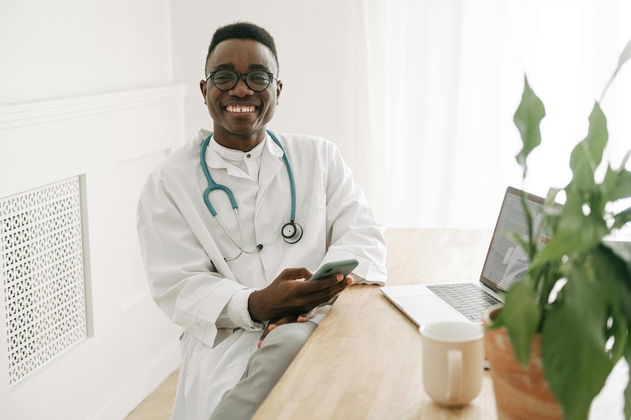 A Smiling doctor reading healthcare research article Holding a Smartphone 